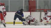  ?? DAVID TURBEN — FOR THE NEWS-HERALD ?? Kenston’s Val Carriero takes a point-blank shot against Mentor goaltender Jake Tackett last season.