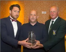  ??  ?? Pádraig Whitty (Pat Whitty’s son) presents the Pat Whitty Special Merit Award to North End United manager John Godkin, with Denis Hennessy, Chairman of the Wexford Football League, at the Horse and Hound player of the year awards.