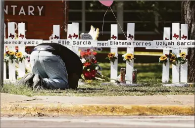  ?? Kin Man Hui / San Antonio Express-News ?? White crosses honor the 21 victims at Robb Elementary School on Wednesday in Uvalde, Texas.