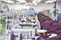  ??  ?? An employee works inside a garment factory of Orient Craft Ltd in Gurgaon on the outskirts of New Delhi. — Reuters