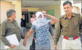  ?? HT PHOTO ?? Accused Paramjeet in the police custody in Rohtak on Sunday.