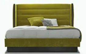  ?? Nathan Anthony ?? Nathan Anthony's Baron bed, shown in Milo honey bee fabric, features horizontal channel tufting on the headboard and side wings covered in knife-edge fabric.