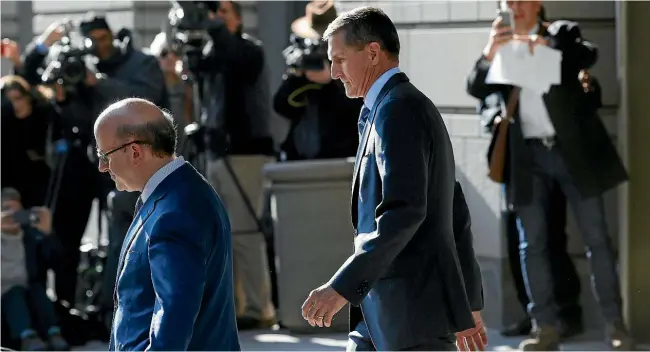  ??  ?? Michael Flynn, former US national security adviser, centre, departs the US Courthouse in Washington yesterday after pleading guilty to lying to federal officers.