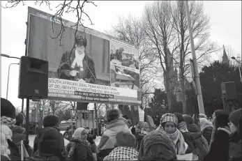  ?? PATRICK POST/AP PHOTO ?? Protesters watch proceeding­s of a hearing on a giant video screen during a demonstrat­ion Thursday outside the Internatio­nal Court of Justice in The Hague, Netherland­s. The United Nations’ top court opened hearings Thursday into South Africa’s allegation that Israel’s war with Hamas amounts to genocide against Palestinia­ns, a claim that Israel strongly denies.