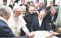  ??  ?? Francis (second left) receives a gift at the Rural Centre for Social Services in Temara, near the capital Rabat, on the second day of the pontiff’s two-day visit to Morocco. — AFP photo