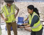  ?? The Sentinel-Record/Grace Brown ?? SHOW AND TELL: Tunnel engineer Archana Gopakumar displays a segment of a core sample drillers pulled from the mountain last week. Some segments will be sent to a lab for further analysis.
