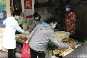  ??  ?? vegetables at a store in Wuhan in central China’s Hubei province on Tuesday. China says almost all of its coronaviru­s cases are now brought into the country by travelers from abroad, and Wuhan has not recorded any new confirmed or suspected cases in a week. (AP/Olivia Zhang)