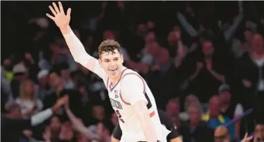  ?? MARY ALTAFFER/AP ?? UConn center Donovan Clingan reacts after dunking during the second half of the Big East Conference Tournament championsh­ip game against Marquette on Saturday in New York. UConn won 73-57.