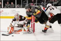  ?? John Locher / Associated Press ?? Vegas’ Jonathan Marchessau­lt attempts a shot on Anaheim goaltender John Gibson in the second period of the Golden Knights’ 7-2 blowout home win on Sunday.