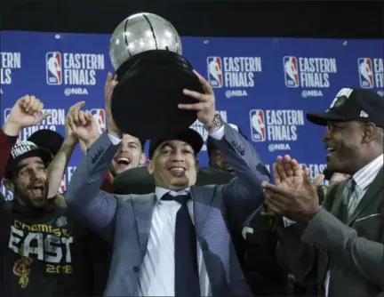  ?? ELISE AMENDOLA — ASSOCIATED PRESS ?? Coach Tyronn Lue hoists the Eastern Conference trophy after his team beat the Celtics, 87-79, in Game 7 on May 27.