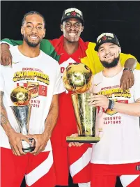  ?? JESSE D. GARRABRANT NBAE/GETTY IMAGES ?? Kawhi Leonard, Pascal Siakam and Fred VanVleet with the spoils of victory after the Raptors’ Game 6 victory in Oakland.