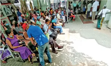  ?? ?? Crowds back at the National Hospital to collect prescribed medicines (above and left). Pix by Akila Jayawardan­a