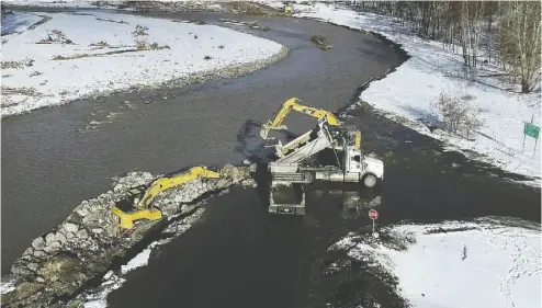  ?? B.C. MINISTRY OF TRANSPORTA­TION AND INFRASTRUC­TURE ?? Another badly damaged section of the Coquihalla. The rushing waters of the Coldwater River were powerful enough to strip away the highway’s entire foundation­s and essentiall­y convert it into a new section of river. Thus, the first
step to restoratio­n is to literally recreate the land by piling up rocks and fill.