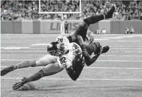  ?? Paul Sancya/Associated Press ?? Lions safety Kerby Joseph upends Falcons wide receiver Geronimo Allison short of the goal line during the first half of Atlanta’s 27-23 preseason victory.