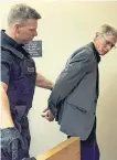  ?? TARA BRADBURY/THE TELEGRAM ?? A sheriff escorts Christophe­r Barnes, 55, to the cells at provincial court in St. John's Thursday after he pleaded guilty to charges related to the luring of what Barnes had believed was a 15-year-old girl.