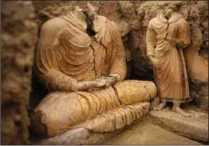  ?? (File Photo/AP/Dusan Vranic) ?? Buddha statues are seen Oct. 12, 2010, inside an ancient temple in Mes Aynak valley.