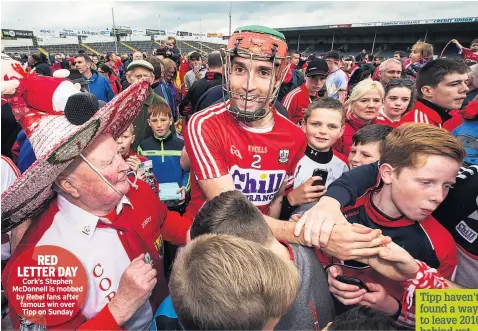  ??  ?? RED LETTER DAY Cork’s Stephen Mcdonnell is mobbed by Rebel fans after famous win over Tipp on Sunday