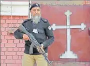  ?? AP ?? A police official stands guard outside a church in Lahore where special services were being organised.