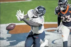  ?? AAron Ontiveroz / The Denver Post ?? Broncos cornerback Michael Ojemudia, right, looks on as Titans WR A.J. Brown tries to snare a pass in the end zone Monday night in Denver.