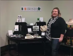  ?? JORDANA JOY —THE MORNING JOURNAL ?? Lorain Historical Society program manager Jillien Zudell shows the new Lorain Internatio­nal Festival Nationalit­y exhibit featuring Irish culture and its connection to Lorain. The exhibit opens March 2at the Carnegie Center, 329W. 10th St. in Lorain.