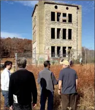  ??  ?? in the Historic Preservati­on Alliance of Arkansas’ 2012 Northwest Arkansas Ramble explore the remnants of the Oklahoma Row Tower at the Monte Ne historic site. Part of the early 20th-century resort community is now under Beaver Lake.