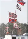  ?? Ric Feld / Associated Press ?? In this March 18, 2005, photo, Confederat­e stars and bars flags fly on poles attached to campers at Atlanta Motor Speedway in Hampton, Ga.