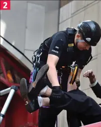  ??  ?? Health and safety: Officers with climbing gear hand out goggles, circled