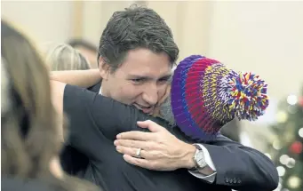  ?? ADRIAN WYLD/THE CANADIAN PRES ?? An aboriginal woman hugs Prime Minister Justin Trudeau before a meeting with national aboriginal organizati­ons on Parliament Hill in 2015. Trudeau has promised to act on all 94 Truth and Reconcilia­tion Commission recommenda­tions, one of which is to...