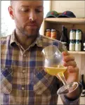  ?? AP PHOTO/LISA RATHKE ?? Colin Davis, co-founder of Shacksbury Cider, samples hard cider at the company's tasting room in Vergennes, Vt.