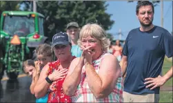  ?? COURTESY OF ANDREW FRANKENFIE­LD ?? Marianne Landis and daughter Jayne Longacre and family watch the tractor parade.