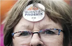  ?? JUSTIN TANG/THE CANADIAN PRESS ?? Shirley Taylor wears a “Burnt by Phoenix” sticker on her forehead during a rally in Ottawa earlier this year.