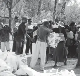  ??  ?? Orphans, the elderly and vulnerable residents of Ward 1, 2 and 3 receive mealie-meal donated by Bulawayo Provincial Affairs Minister Eunice Nomthandaz­o Moyo yesterday