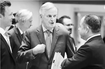  ??  ?? Barnier (left) talks with Polish European Affairs Minister Konrad Szymanski and Austrian European Affairs Minister Gernot Blume (left) ahead of a special European Union General Affairs meeting on Brexit in Brussels. —AFP photo