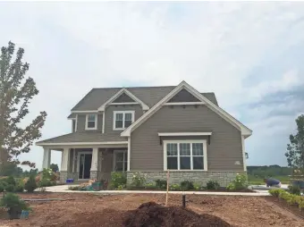  ?? PAUL GORES / MILWAUKEE JOURNAL SENTINEL ?? Constructi­on crews are preparing 22 houses in metro Milwaukee for this year's MBA Parade of Homes, including this one by Aspen Homes in the Fox Meadow subdivisio­n in Menomonee Falls. The parade starts Aug. 12.