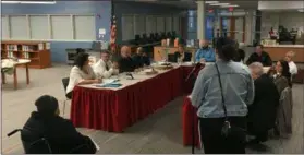  ?? RICHARD PAYERCHIN — THE MORNING JOURNAL ?? Lorain Law Director Pat Riley, second from left seated at the table, addresses residents and the Lorain City School board during the board meeting of Feb. 19. Riley said his department is willing to help the school board, but will need time because the city lawyers are not expert at school law.