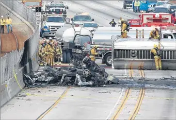  ?? Mel Melcon Los Angeles Times ?? LOS ANGELES COUNTY firefighte­rs at the scene of the accident on the westbound 105 Freeway near Prairie Avenue. “I never thought something like this would happen,” said food truck operator Isabel Larios.