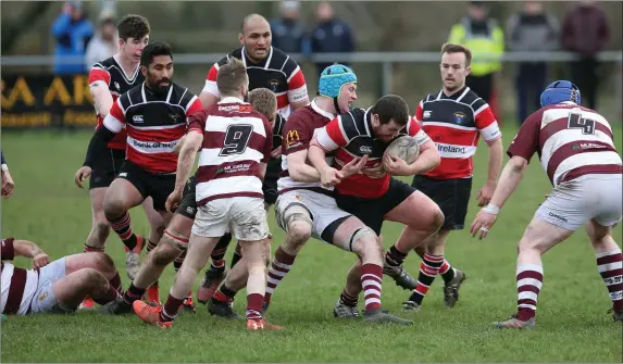  ??  ?? Jack McKenna of Wicklow tries to break a Tullow challenge.