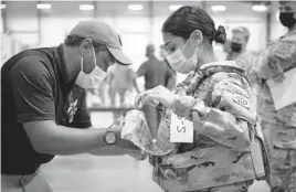  ?? JASON AMADI/U.S. ARMY ?? Sgt. Katiushka Rivera, a soldier assigned to the 82nd Airborne, gets fitted for a modular scalable vest during a fielding event at Fort Bragg, North Carolina.