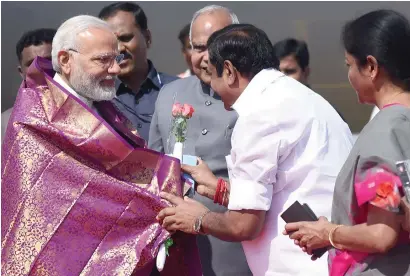  ?? — AFP ?? Narendra Modi is welcomed by Chief Minister of Tamil Nadu Edappadi K. Palaniswam­i on his arrival in Chennai on Thursday.