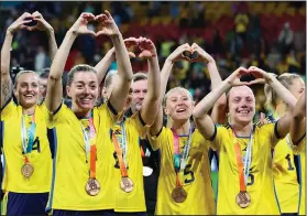  ?? Associated Press ?? Salute: Sweden gesture to supporters as they celebrate with their bronze medals after defeating Australia in the Women's World Cup third place playoff soccer match in Brisbane, Australia, Saturday.