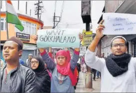  ?? PTI ?? People display placards while taking part in a silent peace rally in Darjeeling on Sunday.