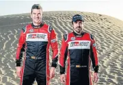  ??  ?? Former F1 champion Fernando Alonso (right) will tackle next month’s Dakar Rally with navigator Mark Coma (left).