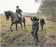  ?? ?? Top, members of the Warwickshi­re Hunt heading out during a “trail hunt” in the English countrysid­e. Above, a hunter with the group filming anti-hunt activists whom she accused of trespassin­g to try to stop a hunt.