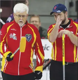  ?? Cp pHoto ?? Team Nunavut skip Jim Nix, left, and third Edmund MacDonald discuss their options during a Brier pre-qualifying match yesterday.