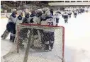  ?? AP Photo/John Wawrow ?? After gathering to celebrate around their goal, Team White players head to center ice to shake hands with their Blue Team counterpar­ts Monday at the HarborCent­er in downtown Buffalo, N.Y. The teams played for more than 250 hours to set the world record...