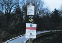  ?? PHOTOS BY SOPHIE PARK THE NEW YORK TIMES ?? RIGHT: A sign at the Nahant Thicket Wildlife Sanctuary warns people about coyotes. Although coyotes regard small pets as prey, attacks on people are rare, according to coyote experts.