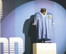  ?? — AFP file photo ?? A jersey worn by Maradona during the 1986 World Cup quarter-final match against England, is pictured during a photocall at Sotheby’s auction house in London.