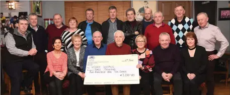  ?? Photo by Michelle Cooper Galvin ?? Judy and Denis Desmond (seated second and third from left) presenting the proceeds of the Rathmore Charity Walk, €3210, to Chairman Pat Doolan and Marian O’Keeffe of the Kerry Hospice with (front from left) Bernadette Desmond, Donal and Margaret O’Keeffe (back from left) Mike O’Sullivan, John O’Donoghue, John O’Sullivan, Peg Murphy, Donal O’Connor, Sean Desmond, Jerry Hickey, Freddie McGillicud­dy, Mike Crowley and Timmy O’Keeffe at The Bridge Bar, Rathmore, on Saturday.