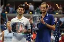  ?? Photograph: Kena Betancur/AFP/Getty ?? Daniil Medvedev and Novak Djokovic hold their trophies after the 2021 US Open final. Images