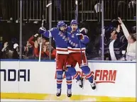  ?? Adam Hunger / Associated Press ?? Rangers left wing Chris Kreider, right, celebrates with center Mika Zibanejad after scoring a goal against the Penguins in Game 1 of their first-round playoff series May 3.